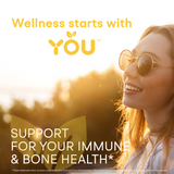 Wellness starts with YOU. Support for your immune and bone health. Image shows a smiling woman in sunglasses enjoying the sunshine.